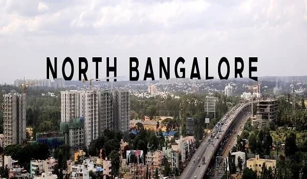 High-angle view of North Bangalore residential corridor and infrastructure projects near the International Airport.